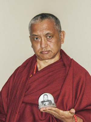 Lama Zopa Rinpoche with glass figure of Lama Yeshe. Photo by Ueli Minder.