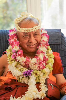 Lama Zopa Rinpoche with flower garlands, 2010. 
