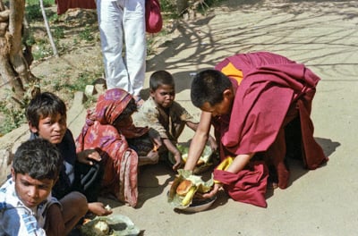 Beggars&#039; banquet, Bodhgaya, India, 1982. Lama Zopa Rinpoche feeding people on the street. 