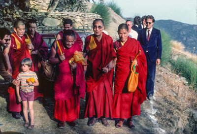 Lama Yeshe with His Holiness the Dalai Lama and entourage arriving at O Sel Ling Retreat Center, Spain, in September, 1982.
