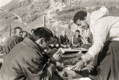 Max Mathews serving Lama Zopa Rinpoche after a Christmas puja, Kopan Monastery, Nepal, 1972.