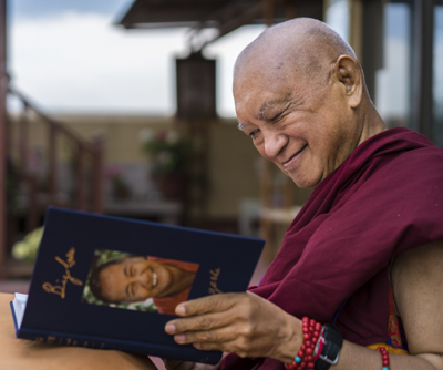 Lama Zopa Rinpoche enjoying his copy of Big Love, Kopan Monastery, Nepal, April 2020. Photo: Ven. Lobsang Sherab.
