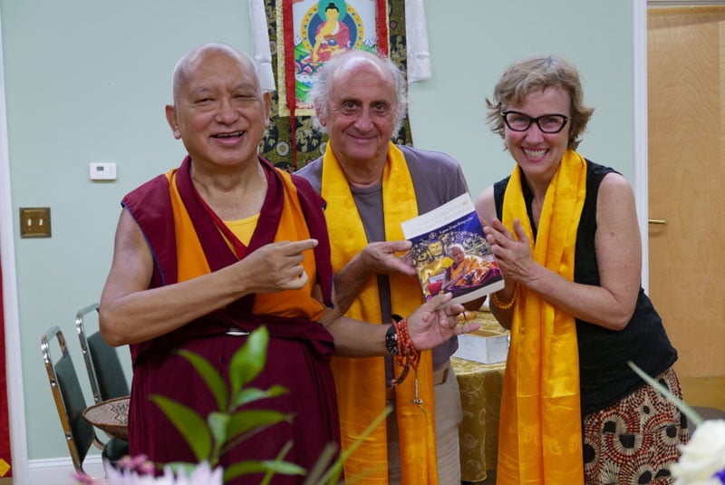 Nick Ribush and Wendy Cook present one of LYWA&#039;s latest publications to Lama Zopa Rinpoche, 2016. Photo: Ven. Roger Kunsang.
