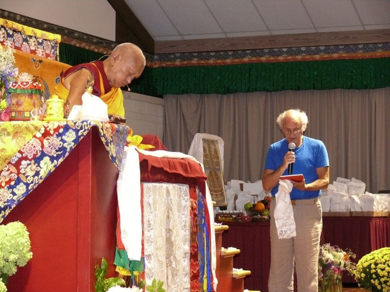 Nick Ribush delivering a request for Lama Zopa Rinpoche&#039;s long life at Light of the Path retreat 2016. Photo: Kalleen Mortensen.