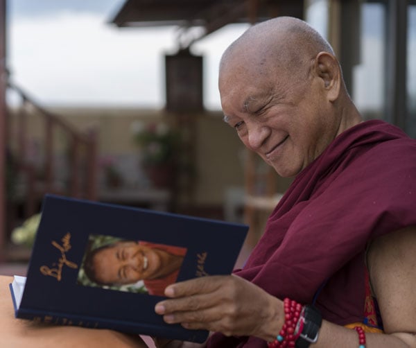 Lama Zopa Rinpoche enjoying his copy of Big Love, Kopan Monastery, Nepal, April 2020. Photo: Ven. Sherab.